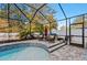 Screened-in pool area with patio furniture and fire pit at 2307 Dakota Rock Dr, Ruskin, FL 33570