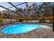 Enclosed pool and spa with patio and string lights at 2307 Dakota Rock Dr, Ruskin, FL 33570