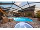 Enclosed pool and spa with patio and string lights at 2307 Dakota Rock Dr, Ruskin, FL 33570