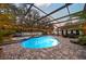 Enclosed pool and spa with patio and string lights at 2307 Dakota Rock Dr, Ruskin, FL 33570