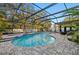 Enclosed pool and spa with patio furniture at 2307 Dakota Rock Dr, Ruskin, FL 33570