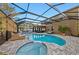 Enclosed pool and spa with patio furniture and lighting at 2307 Dakota Rock Dr, Ruskin, FL 33570