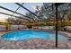 Enclosed pool and spa with patio and string lights at 2307 Dakota Rock Dr, Ruskin, FL 33570