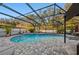 Enclosed pool and spa with patio and string lights at 2307 Dakota Rock Dr, Ruskin, FL 33570