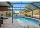Enclosed pool and spa with patio and string lights at 2307 Dakota Rock Dr, Ruskin, FL 33570
