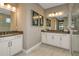 Double vanity bathroom with marble countertops and a large shower at 2471 Overfalls Pl, Wesley Chapel, FL 33543