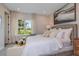 Bright bedroom with large window and plush bedding at 2471 Overfalls Pl, Wesley Chapel, FL 33543