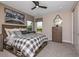 Cozy bedroom with a plaid comforter and large window at 2471 Overfalls Pl, Wesley Chapel, FL 33543