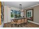 Elegant dining room with a large table, chandelier, and ample natural light at 2471 Overfalls Pl, Wesley Chapel, FL 33543