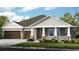 One-story home with two-car garage and attractive landscaping at 2471 Overfalls Pl, Wesley Chapel, FL 33543