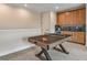 Basement game room with ping pong table and wet bar at 2471 Overfalls Pl, Wesley Chapel, FL 33543