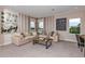 Relaxing game room with sectional sofa and large windows at 2471 Overfalls Pl, Wesley Chapel, FL 33543