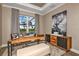 Functional home office with a large desk, built-in shelving, and natural light at 2471 Overfalls Pl, Wesley Chapel, FL 33543