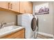 Bright laundry room with washer, dryer, and ample cabinetry at 2471 Overfalls Pl, Wesley Chapel, FL 33543