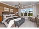 Main bedroom with wood-paneled accent wall and plush bedding at 2471 Overfalls Pl, Wesley Chapel, FL 33543