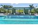 Refreshing pool with shaded cabanas and lounge chairs at 2471 Overfalls Pl, Wesley Chapel, FL 33543