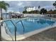 This outdoor pool features a marina view, surrounded by seating and well-maintained landscaping at 255 Dolphin Pt # 811, Clearwater Beach, FL 33767