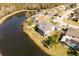 House on a lake with a fenced backyard and a two-car garage at 26932 Sea Breeze Way, Wesley Chapel, FL 33544