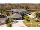 Two-story house with a large driveway and a backyard at 26932 Sea Breeze Way, Wesley Chapel, FL 33544