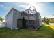 Two-story house with a screened patio and balcony at 26932 Sea Breeze Way, Wesley Chapel, FL 33544