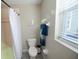 Clean bathroom with shower, toilet, and window at 26932 Sea Breeze Way, Wesley Chapel, FL 33544