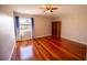 Bright bedroom with hardwood floors and a built-in bookshelf at 26932 Sea Breeze Way, Wesley Chapel, FL 33544