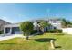 Two-story house with gray siding, attached garage, and manicured lawn at 26932 Sea Breeze Way, Wesley Chapel, FL 33544