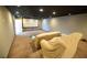 Basement home theater with projector screen and seating at 26932 Sea Breeze Way, Wesley Chapel, FL 33544