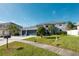Two-story house with a three-car garage and landscaped lawn at 26932 Sea Breeze Way, Wesley Chapel, FL 33544