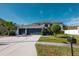 Two-story house with a three-car garage and landscaped lawn at 26932 Sea Breeze Way, Wesley Chapel, FL 33544