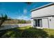 Gray house exterior with backyard and white fence at 26932 Sea Breeze Way, Wesley Chapel, FL 33544