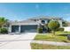 Two-story house with a three-car garage and landscaped lawn at 26932 Sea Breeze Way, Wesley Chapel, FL 33544