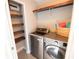 Functional laundry room with washer, dryer, and extra storage at 26932 Sea Breeze Way, Wesley Chapel, FL 33544