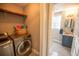 Laundry room with washer, dryer, shelving and extra storage at 26932 Sea Breeze Way, Wesley Chapel, FL 33544