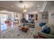 Open living space with comfortable seating, large windows, and views into kitchen at 26932 Sea Breeze Way, Wesley Chapel, FL 33544