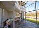Spacious screened patio with seating area and view of the backyard at 26932 Sea Breeze Way, Wesley Chapel, FL 33544