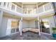 Relaxing screened patio with sectional sofa and view of the backyard at 26932 Sea Breeze Way, Wesley Chapel, FL 33544