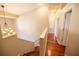 Upstairs hallway with hardwood floors and chandelier at 26932 Sea Breeze Way, Wesley Chapel, FL 33544