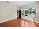Light-filled bedroom with wood floors and large window overlooking pool and backyard at 2902 Big Cypress Way, Wesley Chapel, FL 33544