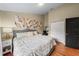 Bright bedroom featuring a comfortable bed, stylish artwork, and a convenient workspace at 2902 Big Cypress Way, Wesley Chapel, FL 33544