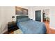 Cozy bedroom featuring hardwood floors and a black, modern nightstand at 2902 Big Cypress Way, Wesley Chapel, FL 33544