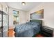 Bedroom with hardwood floors, a window, a decorative painting, and modern shelving at 2902 Big Cypress Way, Wesley Chapel, FL 33544