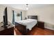 Bedroom with wood floors, bed and window with blue curtains at 2902 Big Cypress Way, Wesley Chapel, FL 33544