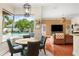View of breakfast nook with view to the pool and backyard and the nearby living room at 2902 Big Cypress Way, Wesley Chapel, FL 33544