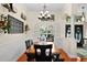 Charming dining room with wood floors, wainscoting, and a decorative chandelier at 2902 Big Cypress Way, Wesley Chapel, FL 33544