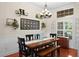 Dining room with dark wood table, bench, and chandelier at 2902 Big Cypress Way, Wesley Chapel, FL 33544