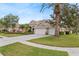 Charming home with a well-manicured lawn, mature trees and three-car garage at 2902 Big Cypress Way, Wesley Chapel, FL 33544