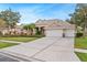 Charming home with a well-manicured lawn, mature trees and three-car garage at 2902 Big Cypress Way, Wesley Chapel, FL 33544