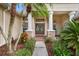 Inviting front entrance with a double door, columns, and lush landscaping at 2902 Big Cypress Way, Wesley Chapel, FL 33544