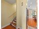 Hallway with wood flooring, staircase, and an archway leading to a living area at 2902 Big Cypress Way, Wesley Chapel, FL 33544
